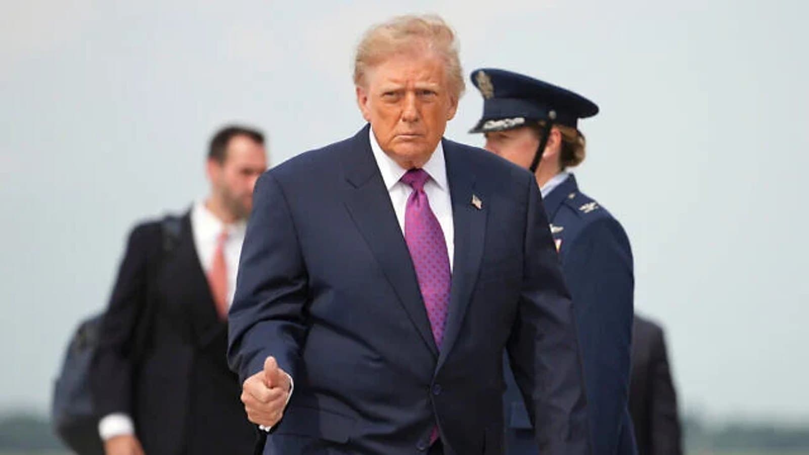 US President Donald Trump walking across an airfield tarmac. File photograph.