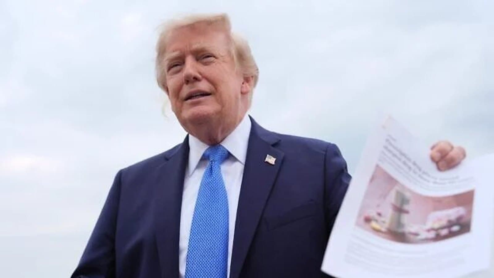 US President Donald Trump holding a printed page while speaking to reporters. File photograph.