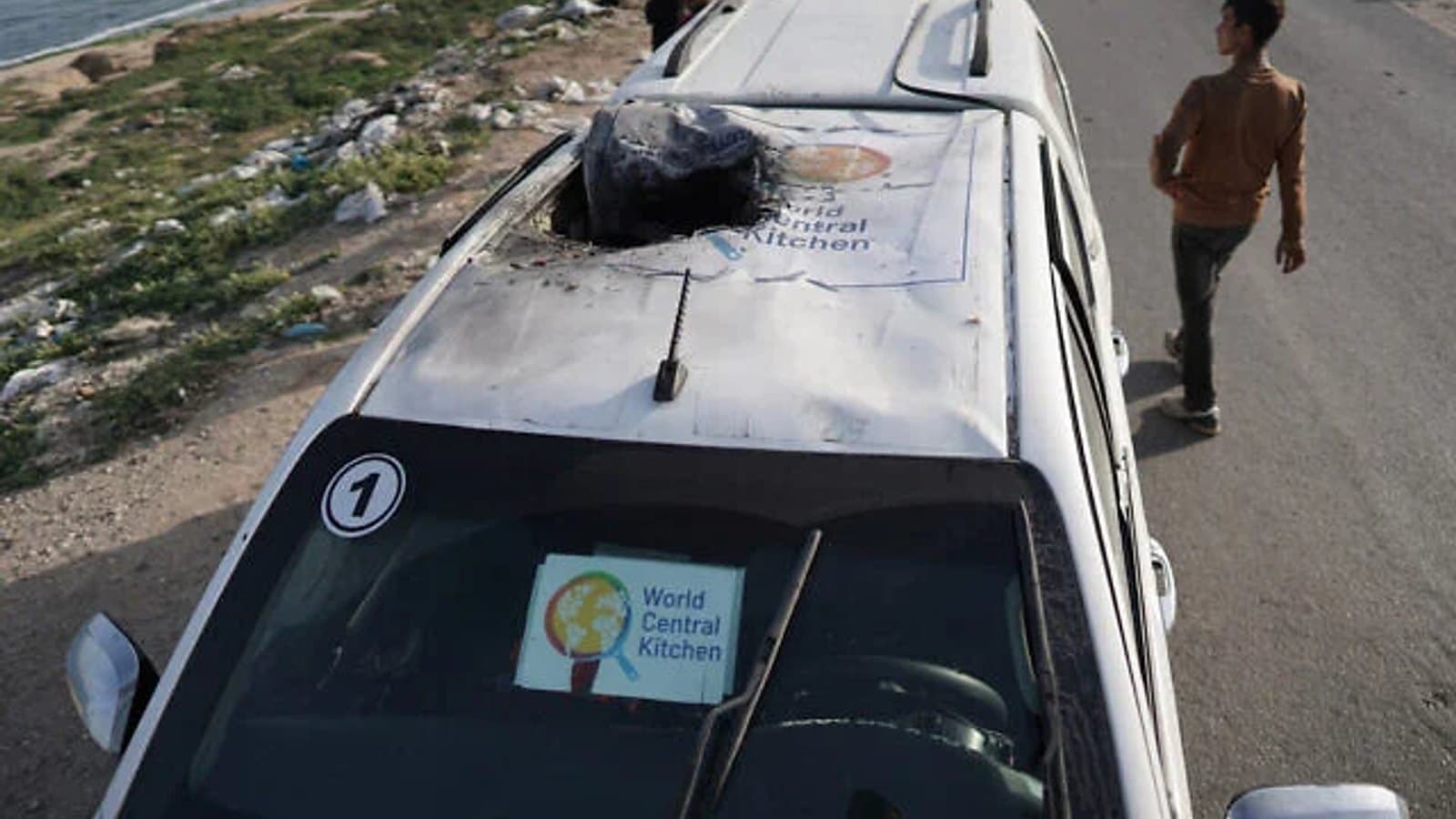 A burned World Central Kitchen vehicle on a road in Gaza, its logo visible on the windshield. File photograph.